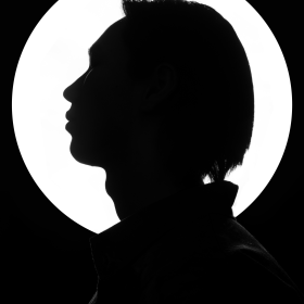 Striking black and white silhouette portrait with a bright background accentuating the profile.