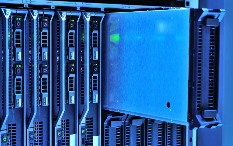 Detailed view of server racks with glowing lights in a data center environment.